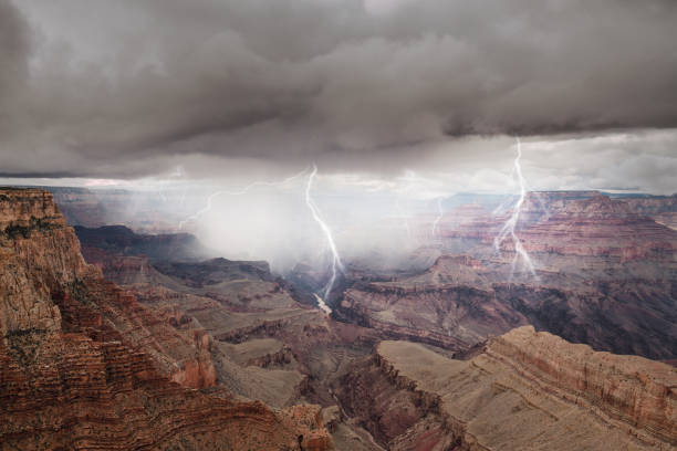 View of high rocky Grand Canyon in Arizona on grey clouds background